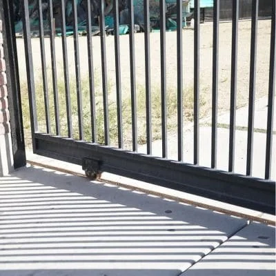 Black aluminum sliding gate with vertical pickets and automated mechanism